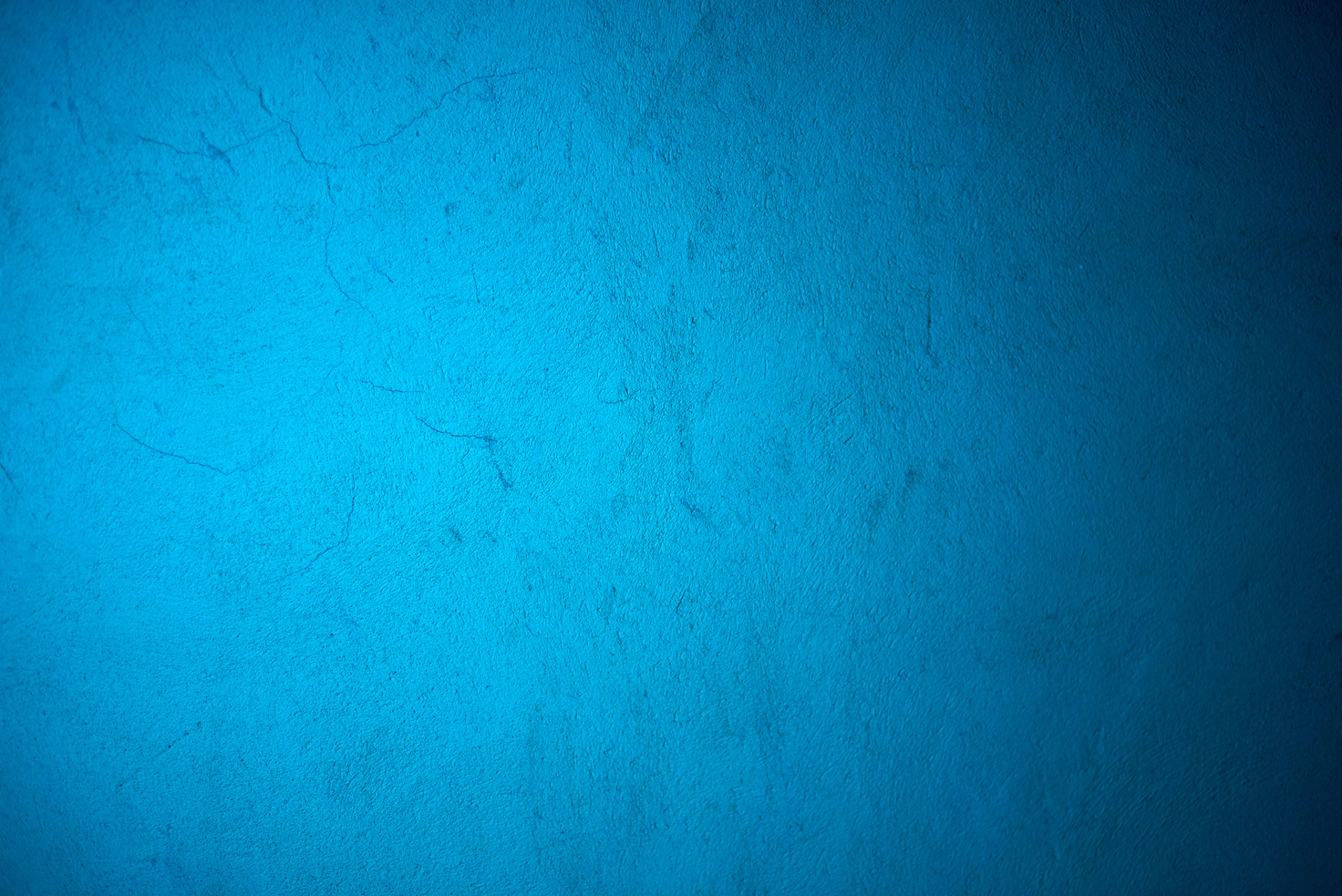 Neon blue light reflecting on concrete wall
